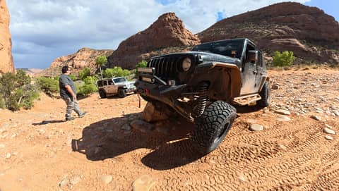 Sucia flexing over a rock obstacle